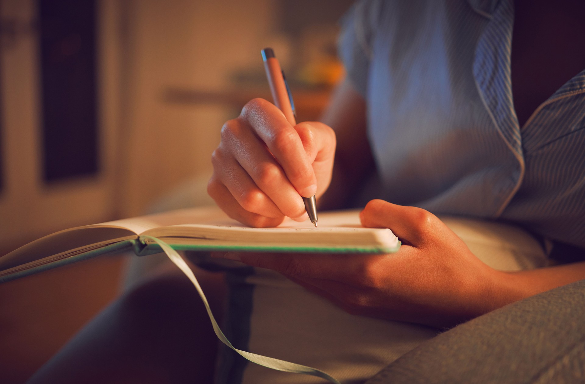 Creative writing at home by female hands enjoying a calm, peaceful day off indoors. Woman making notes in a journal, expressing her feelings and thoughts while making a note of a personal experience